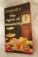 Cover of Seagram's The Spirit of Hospitality showing drinks and snacks, a clock in background.