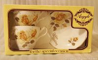 Front view of boxed Argyle golden wedding anniversary tea cup and saucer set