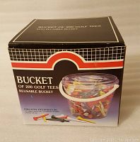 Box of 200 golf tees in a reusable bucket with brand information visible on box