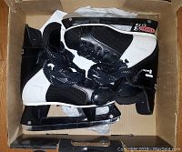 Pair of black and white boys CCM Tacks hockey skates size 3 inside a box.