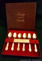 Six gold plated tea spoons arranged in presentation box with Prestige branding and plaque stating 24 karat gold plate.