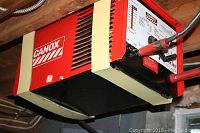 Side view showing red Canox welding machine housing and mounting straps under shelf