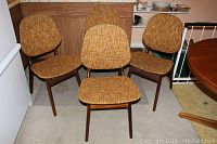 Four chairs arranged in kitchen area, front view