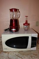 Front and top view of Danby microwave, red Cuisinart blender and Betty Crocker chopper on countertop.