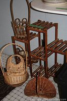 Wooden plant stand and assorted wicker baskets including a handle basket and a cradle basket