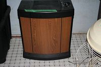 Full view of Kenmore dehumidifier with wood grain front panel, black top and base, showing size and physical condition.