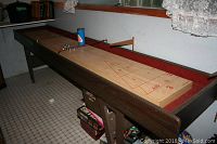 Full length view of shuffleboard table with accessories on top