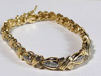Close-up photo of gold plated bracelet showing rope-style links with cubic zirconia accents