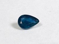 Close-up image of the pear-shaped blue sapphire showing its color and facets.