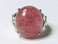 Close-up photo of the cherry red rutilated quartz oval stone set in a 925 sterling silver adjustable ring, showing detailed front view of the stone and band.