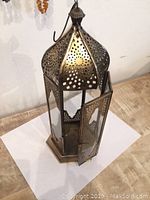 Front angle showing the open door with glass panes and perforated brass top.