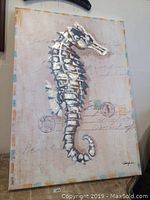 Frontal view of the Seahorse Blues oil painting showing the full canvas with textured seahorse and light script background, mounted on wall.