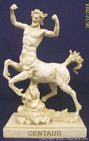 Front and partial side view of cream-colored centaur advertising figurine depicting muscular man torso with raised arms and horse body on label base.