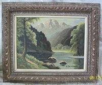 Framed oil painting depicting mountainous landscape with river, trees, and rocks; signed by Yonana; shows overall view including frame with minor wear.