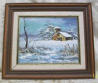 Framed winter landscape oil painting showing barn, trees, snow, and signature 'Davis' on canvas.