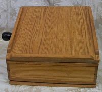 Front view of oak wood lectern showing closed top surface and overall wood grain finish