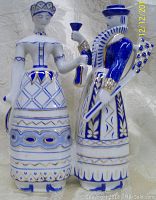 Front view showing the bride and groom porcelain figurine with detailed blue and gold hand-painted accents in traditional Hungarian wedding attire.