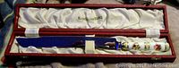 Knife with porcelain floral posie pattern handle and stainless steel blade, displayed inside original fitted red box lined with white satin, gold Royal Crown Derby logo inside lid.