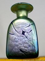 Front view of metallic green iridescent triangular art glass vase with crackle texture and black abstract lines