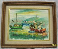 Framed oil painting on canvas showing three boats in a harbor with mountainous background.
