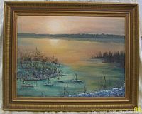 Framed oil painting on canvas showing a calm water scene with reflection of the sunset and reeds, signed by artist Sonja Schmidt in lower left.