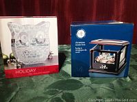 Photo showing the boxed Christmas music box with black lantern-style design and owl tealight holder box with 'Holiday Stuff' label