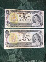 Two 1973 Canadian one dollar bills with consecutive serial numbers shown on the front: BFF1667042 and BFF1667043, featuring Queen Elizabeth II portrait and Bank of Canada crest.