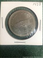Front side of the 1973 Canadian Silver Dollar coin showing the Bluenose schooner and inscriptions.