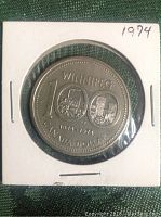 Front side of 1974 Canadian Silver Dollar coin showing Winnipeg Centennial design with 100 year commemoration.