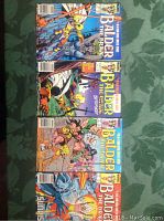 Four Balder The Brave comic books laid out vertically on a green fabric background showing cover art and titles.