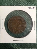 Reverse side of 1918 Canadian penny with year and denomination surrounded by decorative border.