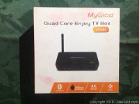 Box packaging showing image of MyGica quad core TV box with key features: Bluetooth, Android 4.4 KitKat, 4K Ultra HD, and KODI.