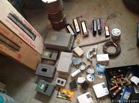 Overview of electric baseboard heaters in boxes, bundled wire, and assorted electrical parts spread on floor.