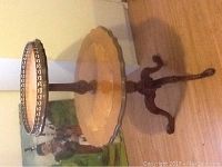 Full view of the Florentine two-tier side table with distinct carved legs and scalloped edges.