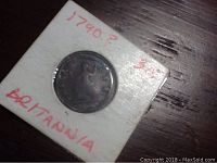 Photo of Britannia coin in holder with handwritten date '1790?' and inscription 'Britannia'