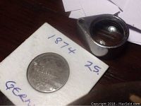 Front side of coin showing denomination and year on card holder.