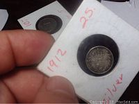 Front view of the 1912 British 3 pence coin inside protective holder showing the denomination and crowned design.