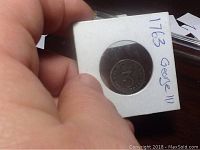 Front view of 1763 George III silver 3 pence coin, showing denomination '3' within a crowned circular design.