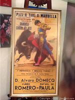 Full view of framed vintage bullfighting poster showing matador fighting bull with text detailing event at Plaza de Toros de Marbella, dated August 25, 1974.