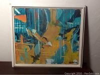Frontal view of the framed abstract painting showing overall composition and colors.