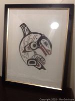 Full view of the framed artwork leaning against a wall