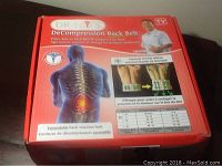 Red box packaging for Dr Ho Decompression Back Belt showing product use and anatomical illustration.