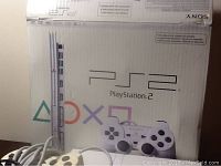 PlayStation 2 ceramic white model box front showing console and controller images