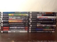 Photo showing stacks of 20 PlayStation 2 game DVDs with visible titles on spines.