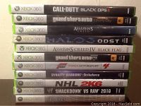Photo showing a vertical stack of 11 Xbox 360 game DVDs with spines facing forward, displaying all titles clearly.