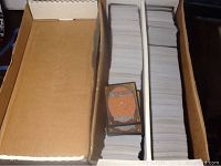 Cardboard box with two compartments holding stacks of trading cards