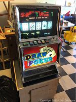 Full view of Draw Poker video game cabinet on its wooden stand