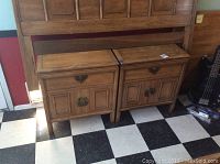 Two vintage wooden end tables placed side by side under a larger wooden piece, showing overall design and condition.