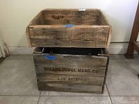 Photo showing two stacked rustic wooden crates, the bottom one marked with Phelps Dodge Merc Co. Ajo Arizona text on the side.