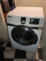 Front view of white Samsung washer showing door and control panel